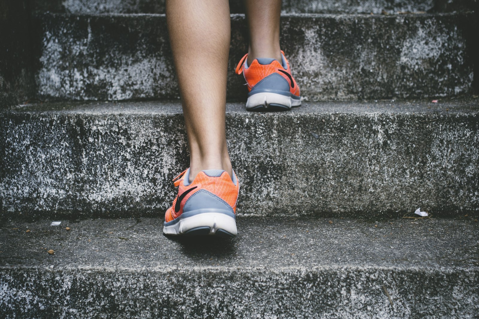 A person running up outdoor steps